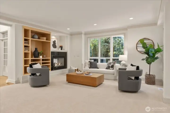 Expansive great room with plush new carpeting (2026), tray ceilings, and a double-sided gas fireplace—designed for both everyday living and entertaining.