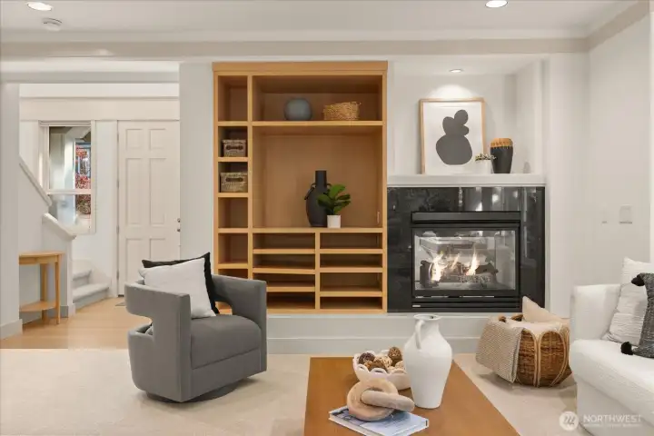 Double-sided gas fireplace with custom built-in shelving creates a warm, inviting focal point.