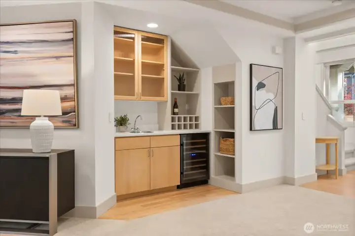 Stylish wet bar with new quartz countertops (2026), built-in beverage fridge, and ample cabinetry—perfect for entertaining.