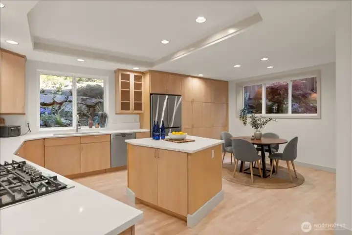Spacious kitchen with quartz countertops (2026), abundant cabinetry, center island, and sunny breakfast nook.
