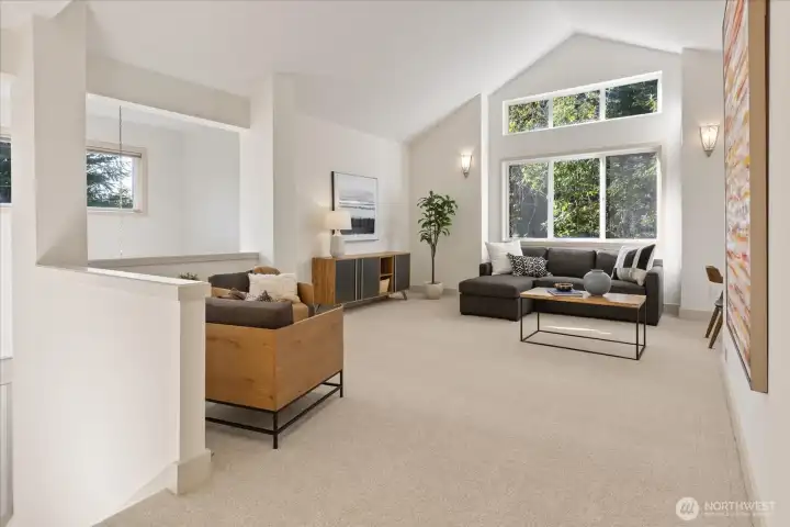 Spacious bonus room with vaulted ceilings, new carpeting (2026), and updated outlets and dimmer switches—part of a thoughtful, whole-home electrical refresh.
