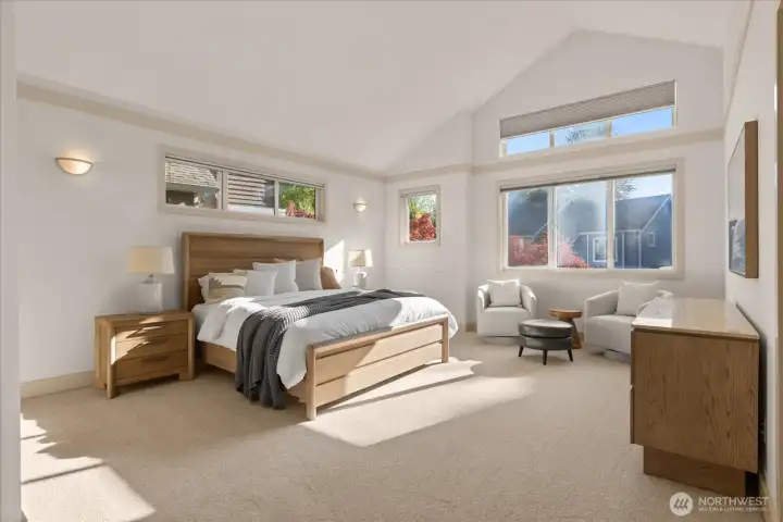 Spacious primary suite with vaulted ceilings, abundant natural light, a comfortable sitting area, and an expansive walk-in closet—designed for rest and retreat. Updated Lutron outlets and cover plates continue the home’s thoughtful upgrades throughout.