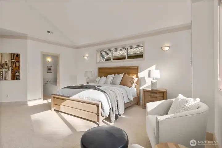 Light-filled primary retreat with vaulted ceilings, serene outlooks, and a generous walk-in closet offering excellent storage.