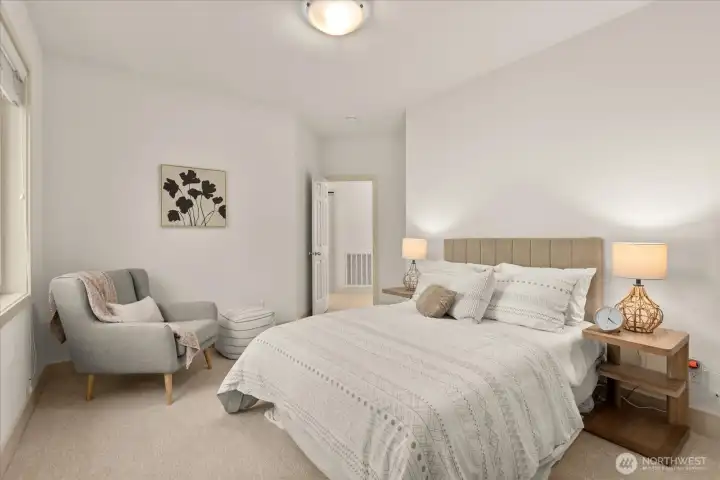 Bright and comfortable secondary bedroom with soft natural light and updated Lutron outlets and cover plates—consistent with upgrades throughout the home.