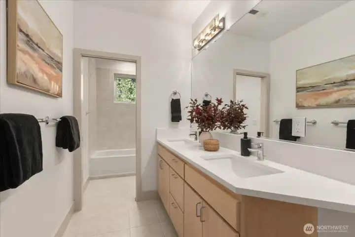 Well-appointed bathroom with dual vanity, updated lighting, and refreshed finishes—clean, bright, and functional for everyday living.