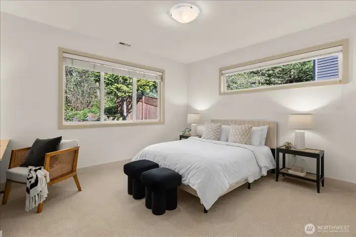 Versatile bedroom featuring ample closet space and a dedicated workspace—standing desk included with the home, offering added flexibility for work or study.