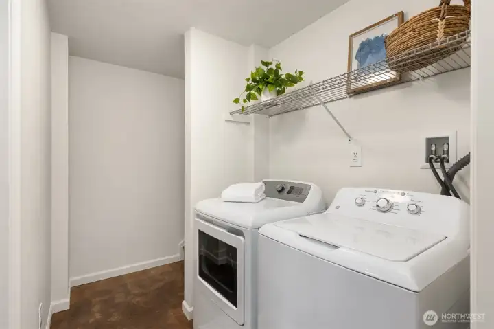 Laundry area with storage shelves. Laundry area with storage shelves.