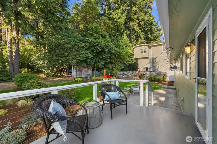 Back porch offers a private seating area overlooking the fenced backyard. Back porch offers a private seating area overlooking the fenced backyard.