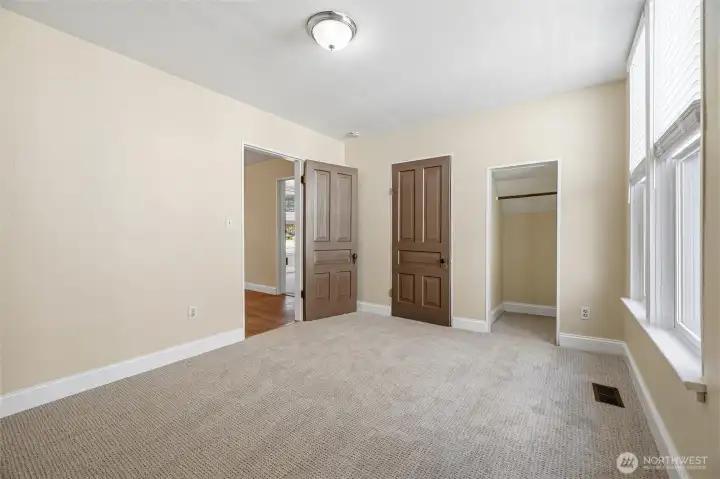 One of two main floor bedrooms. New carpet and paint. This bedroom has two closets (one with a door on it, one without.) One of two main floor bedrooms. New carpet and paint. This bedroom has two closets (one with a door on it, one without.)