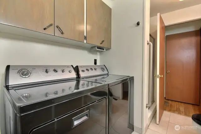 Combined laundry room and 3/4 bath.  Both washer and dryer stay!