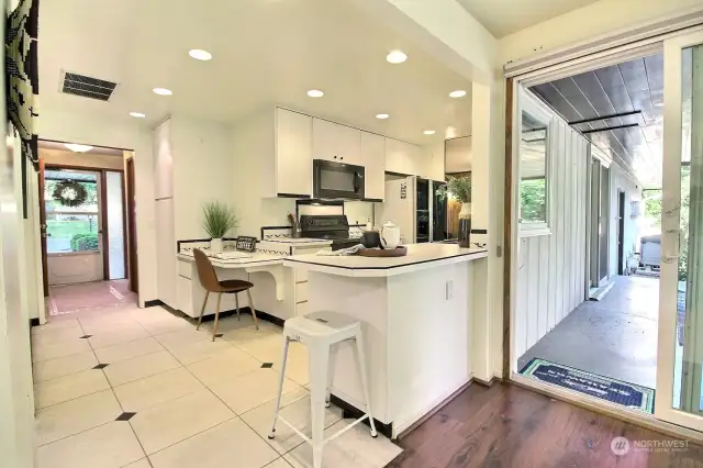 A well suited built-in desk, pantry storage, and convenient eating bar make this an ideal kitchen.
