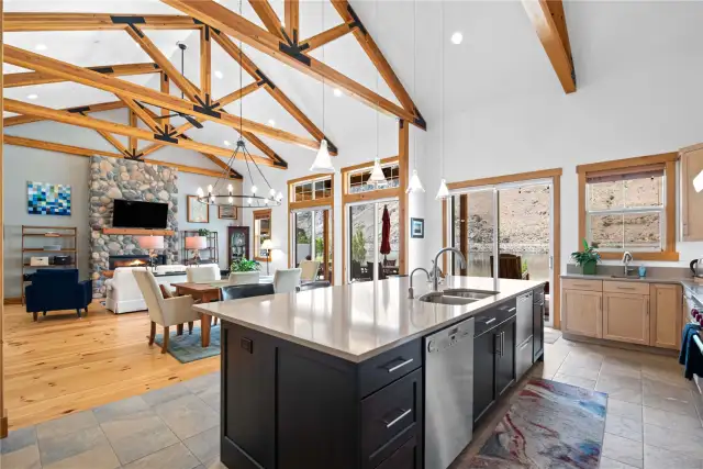 View 3 of Entertainer's kitchen featuring high-end appliances (Sub-Zero/Wolf/Miele/Fisher-Paykel/Franke), radiant heated tile floors & massive quartz island.