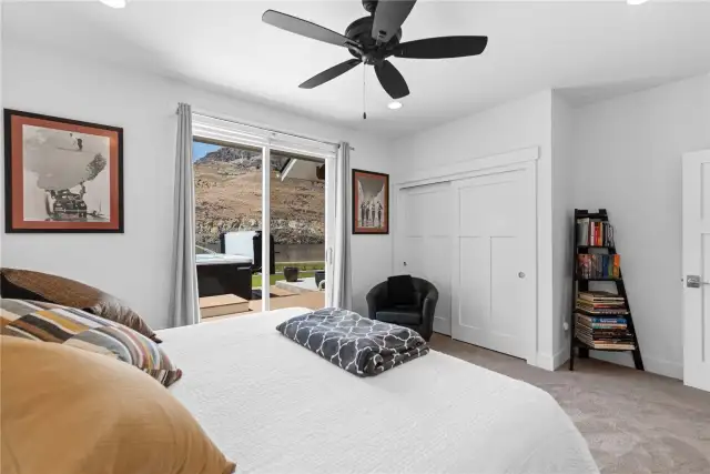 View 2 of Guest Bedroom 1 with glass sliding doors leading to the outdoor living area and swim spa overlooking the Columbia River.