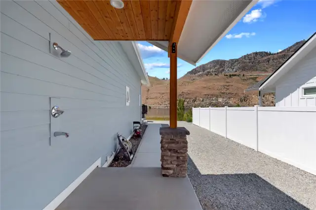 Outdoor shower and side yard with ample room for boat and trailer storage.