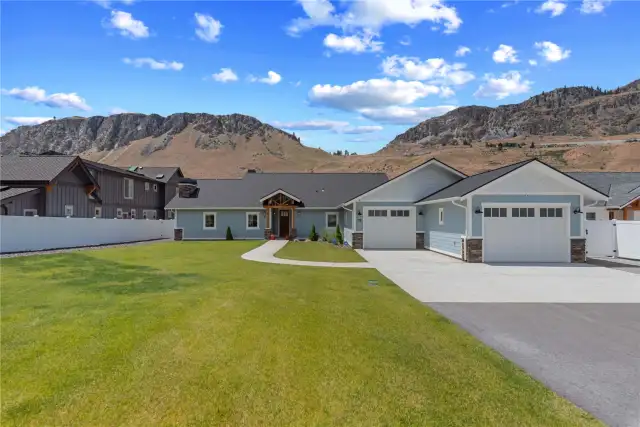 Exterior view of front door and landscaped yard.