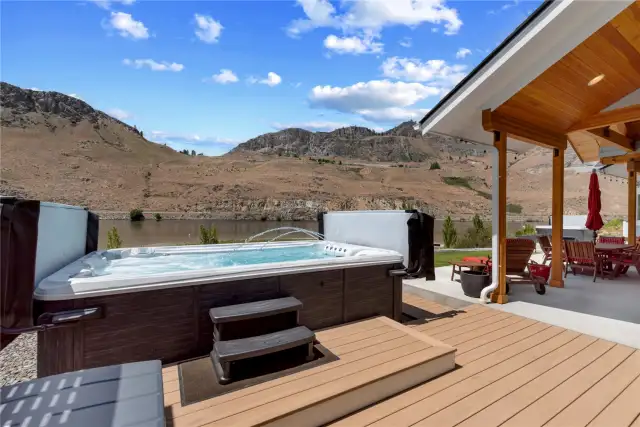 Outdoor Living area with custom swim spa and lounge area overlooking the Columbia River and sandy waterfront beach area.