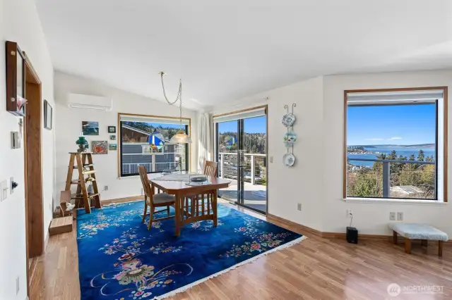 Dining room just off the kitchen and sliding glass door to deck. You can see that there is a mini ductless for heat & AC. Beautiful laminate flooring.