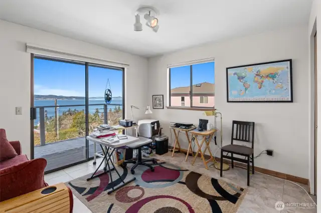 Bedroom on the main level used as an office. There is another sliding glass door out to the deck.