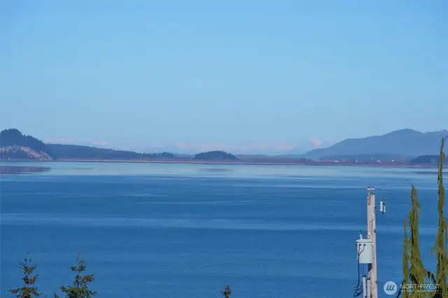 View from deck looking up towards the Canadian Cascade Mountains, Grouse Mountain and La Conner.  What a magical place to live! Sit on your deck and watch whales, boat traffic, & Victoria Clipper ferry.