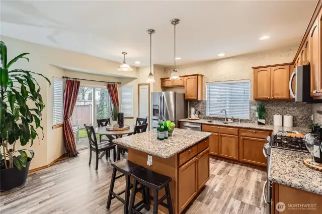 Elegant kitchen with central island and breakfast nook. Patio just outside the sliding door is perfect for coffee and BBQ's.