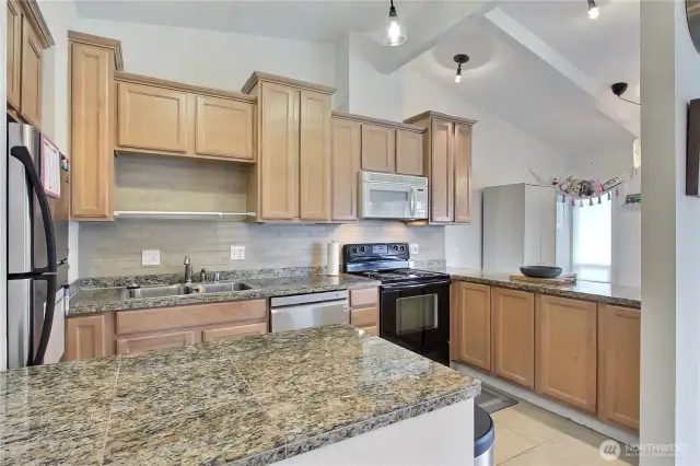 Another view of the spacious kitchen with beautiful granite countertops.