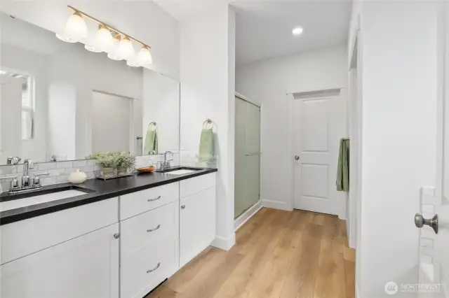 Primary en-suite with double sinks, walk in shower, soaking tub and walk in closet.