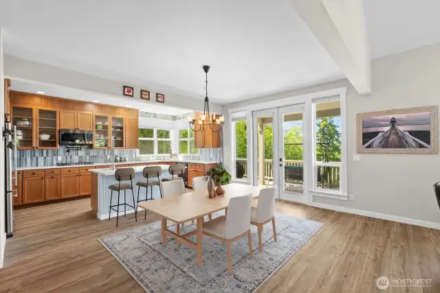 The dining room and kitchen, enjoy French doors that open to the large covered deck.
