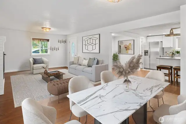 Welcoming living area with laminate hardwoods that open to the kitchen with eat in nook. (virtually staged)