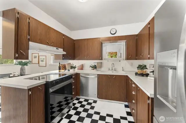 Spacious kitchen featuring brand-new stainless steel appliances, abundant cabinetry, and a functional U-shaped layout.