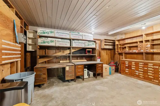 Dedicated workshop with built-in benches, custom storage drawers, and shelving — ideal for woodworking, carpentry, or hobby projects.