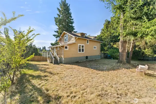 Oversized 10,000 sq. ft. lot with apple and pear trees, offering space for gardening, play, entertaining, or future expansion.