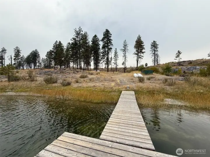 Looking back to shore at the building/camp site. The well is housed inside the protective green container to the right above the dock.