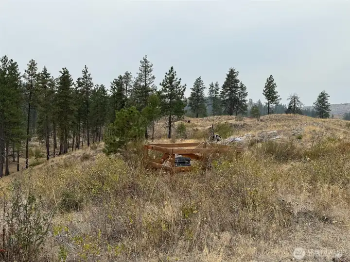 Buried 1000 gallon cistern on the ridge above the building site.