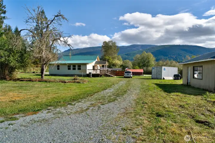 Level property with driveway parking, shed space to the right.
