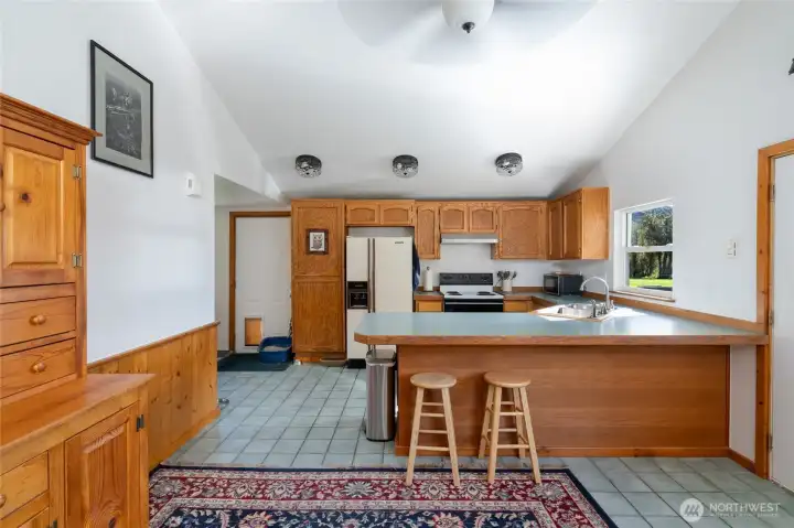 Step inside to vaulted ceilings and tile floors. Spacious kitchen with peninsula seating.