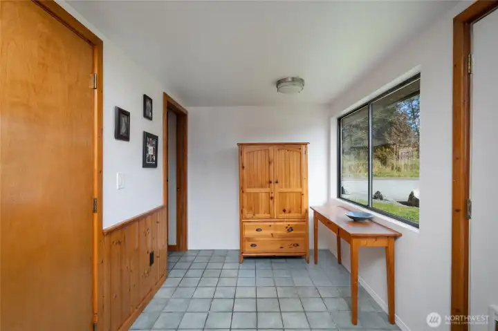 Side room off kitchen. Door to right leads to deck, closet to near left, bedroom and bath to far left.