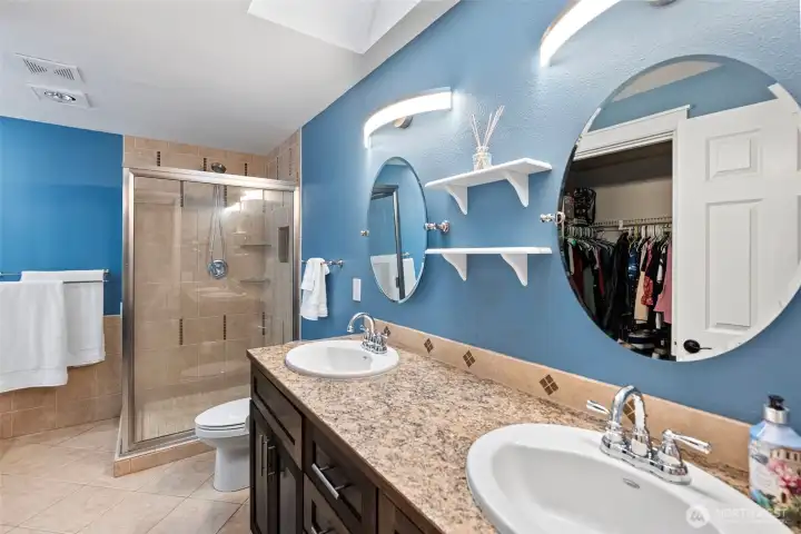 Primary bath with walk in shower and dual vanity . Same custom cabinets here!