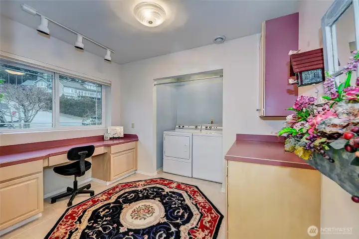 Large Main Level Utility Room. Storage Cabinets & Office Area.