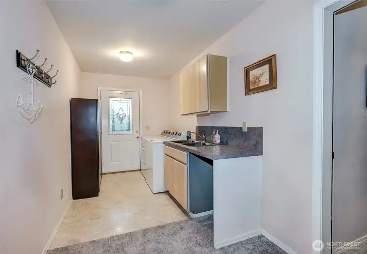 Downstairs Utility Room w/Washer/Dryer, Sink, And 2 Car Garage Access.
