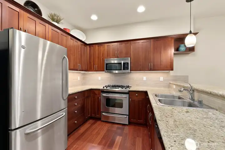 Full kitchen with under cabinet lighting, stainless steel appliances - including a gas range. Also, Cherry stained alder cabinets and granite countertops.