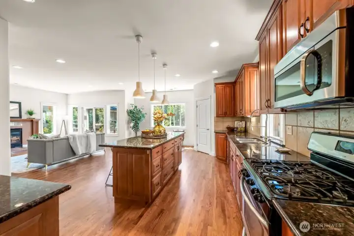 Gourmet kitchen with abundace of high quality cabinets, granite countertops, entertainment size island.