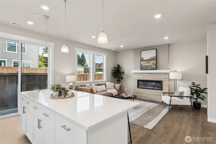 Main level gathering space with large windows and natural flow to the living space.  Colors will vary