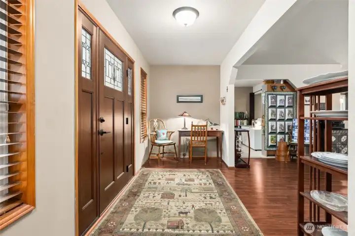 Inviting entry with new craftsman-style door. Warm walnut hardwood flooring throughout most of the main living area.