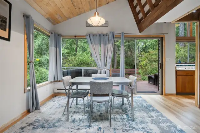 Dining area nest to deck slider with kitchen to right.