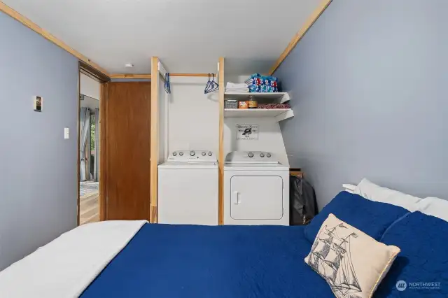 Main floor bedroom with washer/dryer and storage.