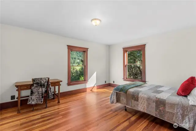 Large second bedroom with views of the mountains and pasture beyond.