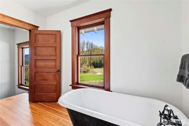 Second floor full bathroom with a peaceful, wooded view as you soak in the clawfoot tub.