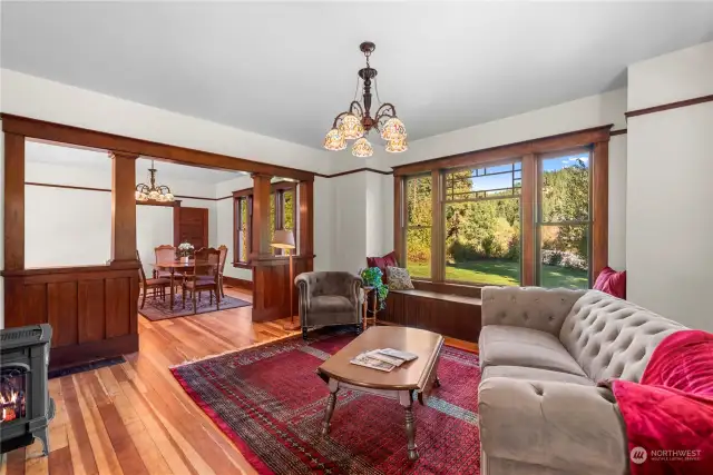 Spacious living room with comfortable window seat overlooking the back yard.