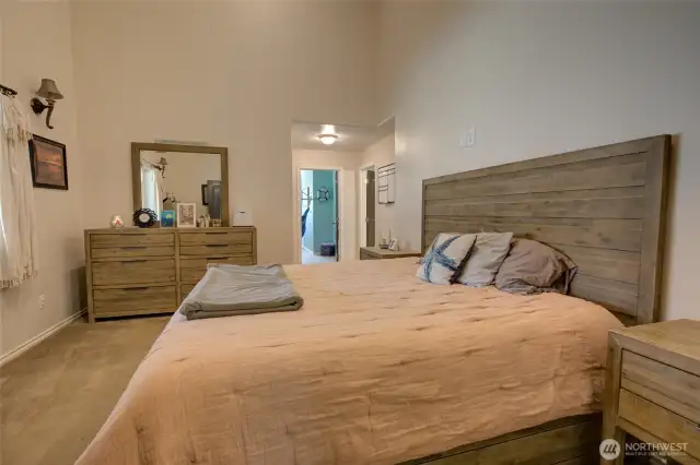 Primary bedroom with vaulted ceilings.