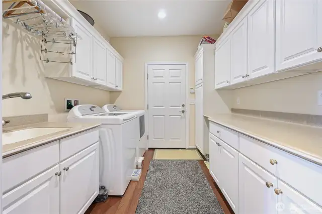 Large laundry room is just off the garage. Sink and lots of storage.